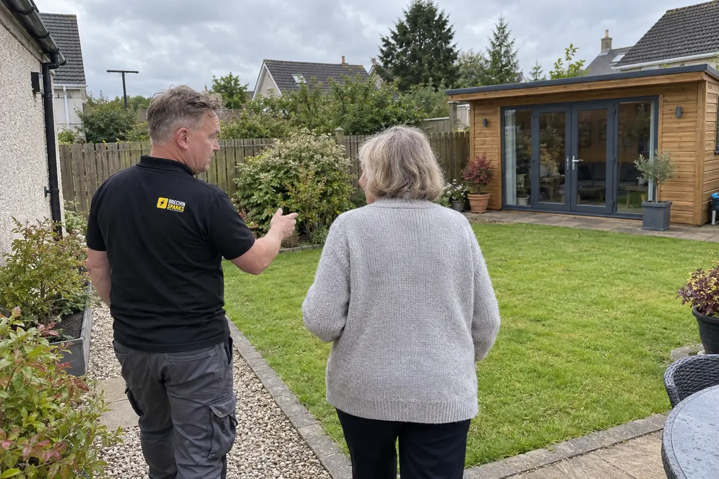 James and a homeowner looking towards a garden room